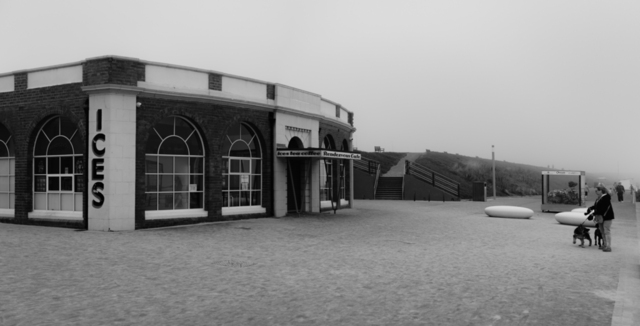 A black and white photograph of the Rendezvous Cafe and Whitley Bay promenade in the fog